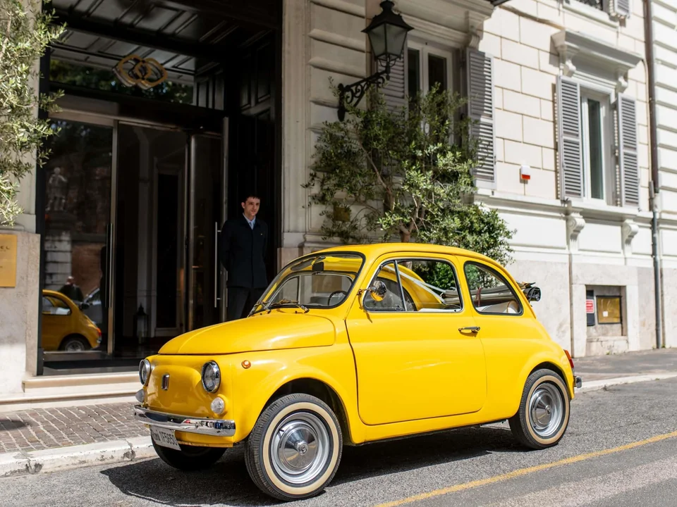 Entrance of Sofitel Rome Villa Borghese with a yellow car outside