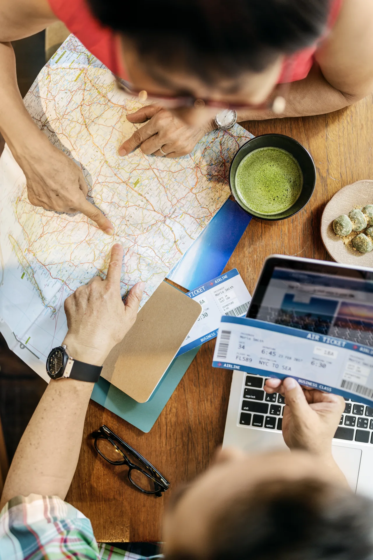 Travellers planning a trip with a map and tickets